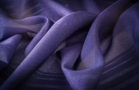 Silk fabric with blue stripes. Abstract silk tones in sapphire tones. Vintage pattern on the fabric....