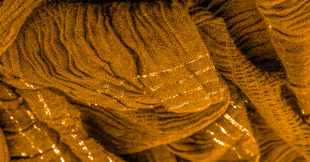 brown yellow silk fabric. Shirred fabrics, fabrics with parallel or diagonal folds with serrated folds.の写真素材