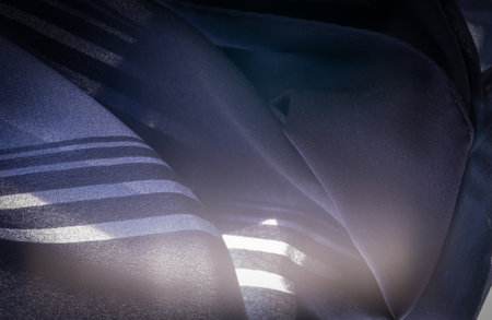 Silk fabric with blue stripes. Abstract silk tones in sapphire tones. Vintage pattern on the fabric. Background texture, decorative ornamentの写真素材