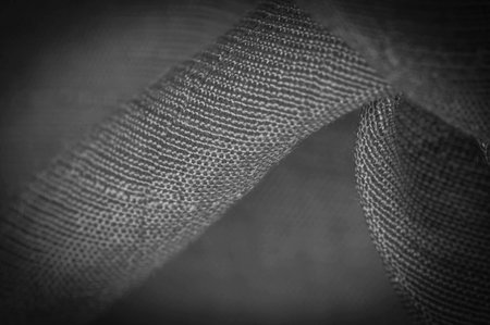 black fabric, deep black silk, woven fabric texture background. Decorative items close-up. Wallpaper...