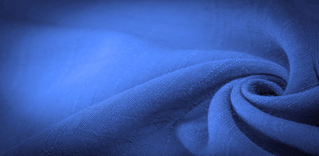 Blue fabric, dark sapphire silk, bright sunny abstract background illustration. Decorative items close-up. Wallpaper texture, backgroundの写真素材