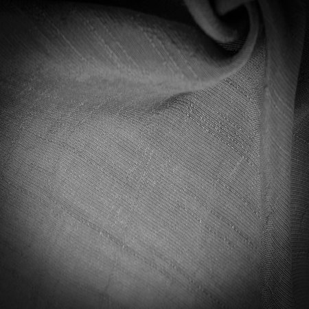 black fabric, deep black silk, woven fabric texture background. Decorative items close-up. Wallpaper texture, backgroundの写真素材