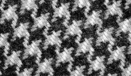 The fabric is dense, warm with a checkered pattern in black. Background texture pattern.