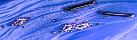 Background design texture, silk pattern, blue fabric with glued decorative faceted stonesの写真素材