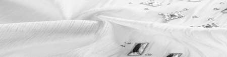Silk pattern, white fabric with glued decorative faceted stones. texture background with bright colorful stones, texture background designの写真素材
