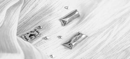 Silk pattern, white fabric with glued decorative faceted stones. texture background with bright colorful stones, texture background designの写真素材