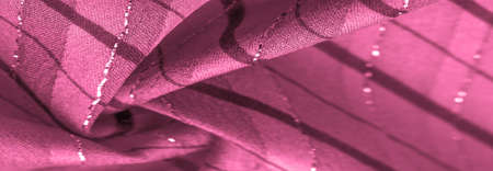 red cerise fabric with lurex stripes, perfect for a fresh and comfortable style.の写真素材