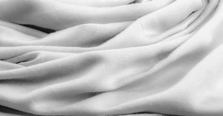 Texture, background, design, white fabric, twill. Thin fabric with diagonal weaving of threads. From Latin and French, the name of the material is translated as âsilkâ.の写真素材
