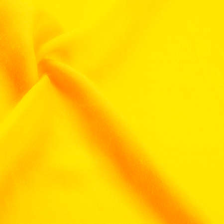 Texture, background, design, yellow gold fabric, twill. Thin fabric with diagonal weaving of threads. From Latin and French, the name of the material is translated as âsilkâ.の写真素材