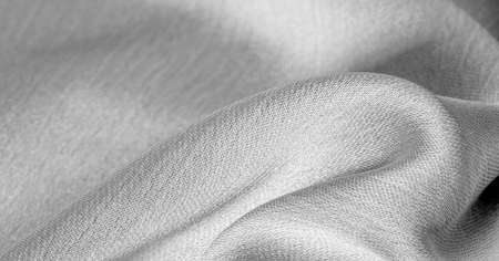 white silk fabric. It has a smooth matte finish. Use this luxurious fabric for anything - from design to your projects. Background, pattern, textureの写真素材