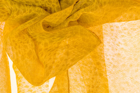 The texture, background, pattern, white yellow silk fabric is textile. Its properties differ from the woven material in that it is more flexible and easier to design.の写真素材