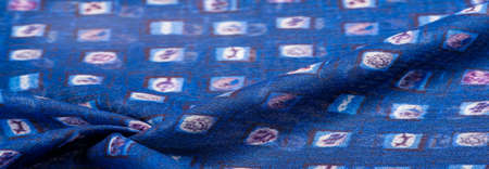 blue silk fabric, delicate weaving, print of a children's toy in a cage, design, openwork weaving. Texture, backgroundの写真素材