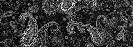 Paisley black-white pattern on a black background. decorated the bandanas of cowboys and bikers popularized by The Beatles, ushered in the era of hippies and became the emblem of rock and roll.の写真素材