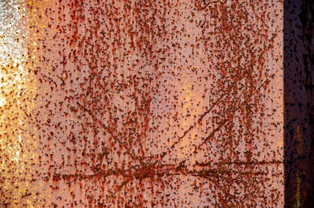 Rust on metal. Texture, background, pattern. When iron comes into contact with water and oxygen, it rusts. If salt is present, such as in seawater or salt spray, iron tends to rust more rapidly.の写真素材