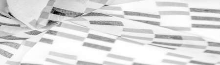 White silk fabric with black geometric rhombus shapes. dark. Background. Template.の写真素材