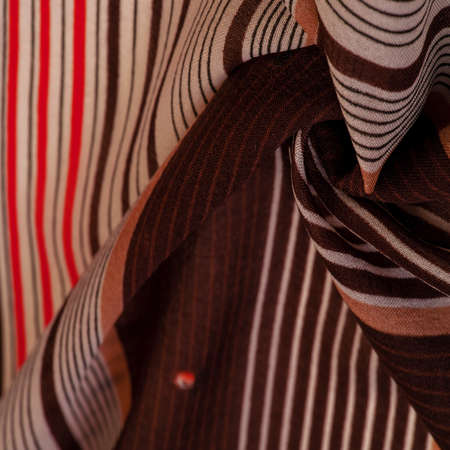 silk fabric, brown background with striped pattern of white and red lines, spanish theme, texture, pattern, collectionの写真素材
