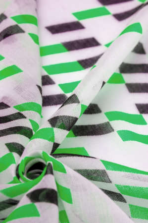 White silk fabric with green and black geometric rhombus shapes. abstract drawing chartreuse franc, close up, background for design, vintage bright pattern. Texture. Background. Template.の写真素材