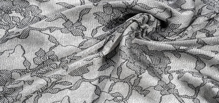 Silk fabric in black and white with lace pattern. This elastic lace trim adds softness to...