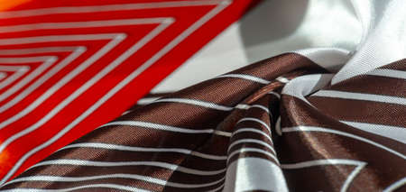 silk fabric with a red-brown pattern with white stripes. Poncho with Mexican motives. texture, backgroundの写真素材