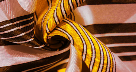 Texture, background, silk fabric with a yellow striped pattern. The design of this fabric is dedicated to a white rabbit mosaic representing the look of a fabulous vest.の写真素材