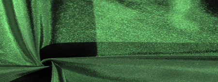 emerald green silk fabric, metallic fabric shades, shiny green metallic background for decorative design, decor element, wallpaper. texture patternの写真素材