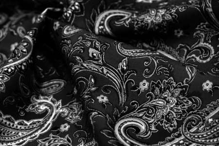 Paisley black-white pattern on a black background.の写真素材