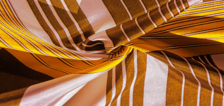 silk fabric with yellow striped pattern. Poncho with Mexican motives. texture, background