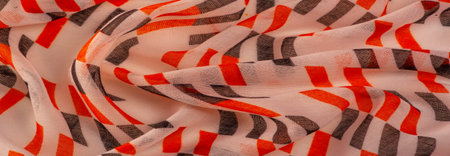 Texture. Background. Template. Beige silk fabric with red and black geometric rhombus shapes.