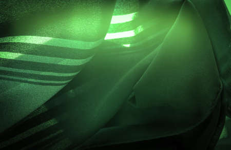Green silk striped fabric. striped organza fabric. Background texture, decorative ornament. Background textureの写真素材