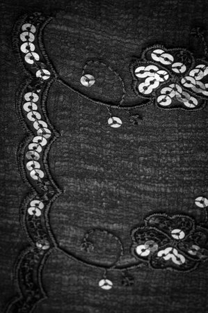 Silk black. The fabric is embellished with sequins. background, silk satin, luxurious texture, dark fabric, costume cotton material, abstract color image pattern, delicate liquid charcoal velvetの写真素材