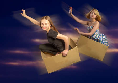 Portrait of a girl. Flying in a box in a dream and in reality. A humorous photo with humorous overtones. Children's fantasies.の写真素材