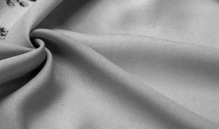 Silk fabric. crepe de chin. The color is black, the flowers are gray. It is a group of silk characterized by roughness and also slightly wrinkled.の写真素材