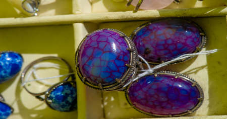 Texture, background, pattern. Folk art. Women's earrings are a piece of jewelry that is worn on the earlobe or edge of the ear. shackle, eardrop, link, connecting link, hangerの写真素材