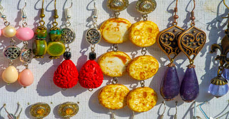 Texture, background, pattern. Folk art. Women's earrings are a piece of jewelry that is worn on the earlobe or edge of the ear. shackle, eardrop, link, connecting link, hangerの写真素材