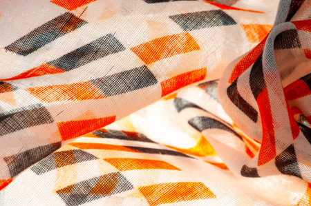 Texture. Background. Template. Beige silk fabric with red and black geometric rhombus shapes.