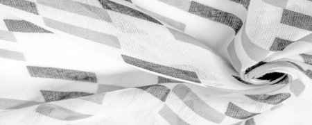 White silk fabric with black geometric rhombus shapes. dark. Background. Template.