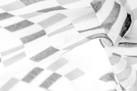 White silk fabric with black geometric rhombus shapes. dark. Background. Template.