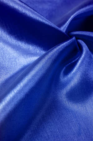 Background texture, silk fabric, shiny blue burgundy, with a small abstract print of rock paintingsの写真素材