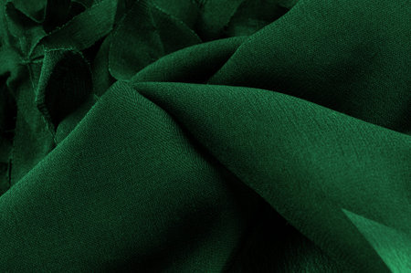Texture. Background. Green silk fabric, view from above. Smooth elegant green silk or satin luxury cloth texture can use as abstract background with copy space.の写真素材