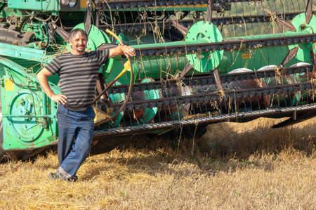 The summer photo of barley harvesting, The modern combine, is a universal machine designed for the efficient collection of various crops. 2019 09 06 Tukaevsky District Tatarstan Russiaのeditorial素材