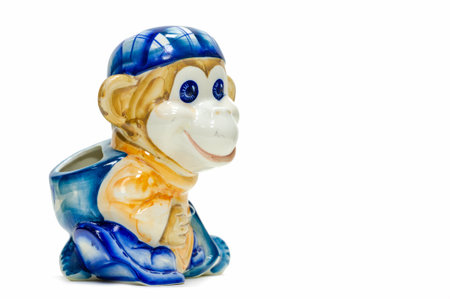 figurine of a playful monkey with a backpack and a baseball cap. Pencil holder. painted with...