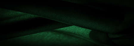 Sheer dark green chiffon silk, Emerald abstract background. Green fabric closeup. - it is a soft transparent fabric with a slight roughness (matte, crepe) due to the use of twisted yarn. textureの写真素材