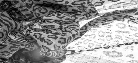 silk fabric black and white with leopard print. Lightweight silk with leopard print will perfectly match your design, looks stylish and not vulgar! Texture, background, patternの写真素材