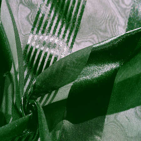 Silk fabric. light transparent silk fabric with stripes of different sizes, green. texture, background, patternの写真素材