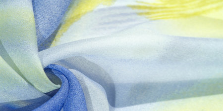 silk fabric in soft blue, yellow and white tones with abstract patterns and bed tones. Texture,...