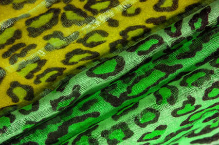 silk fabric green yellow with leopard print. Lightweight leopard print silk is perfect for your design, looks stylish and not vulgar! Texture, background, patternの写真素材