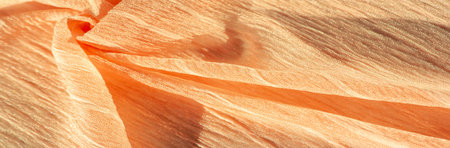 Silk fabric. Texture of brown wrinkled fabric. Brown wrinkled, wavy surface texture. Close-up, soft...