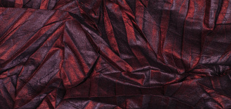 black silk fabric with red stripes, wrinkled fabric. texture. Abstract dark black background,...