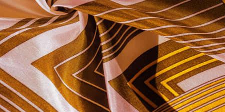 silk fabric with yellow striped pattern. Poncho with Mexican motives. texture, backgroundの写真素材
