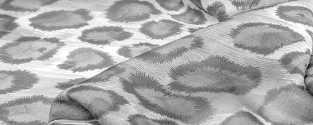 monochrome silk fabric, cheetah skin, african savannah theme. Background texture, pattern